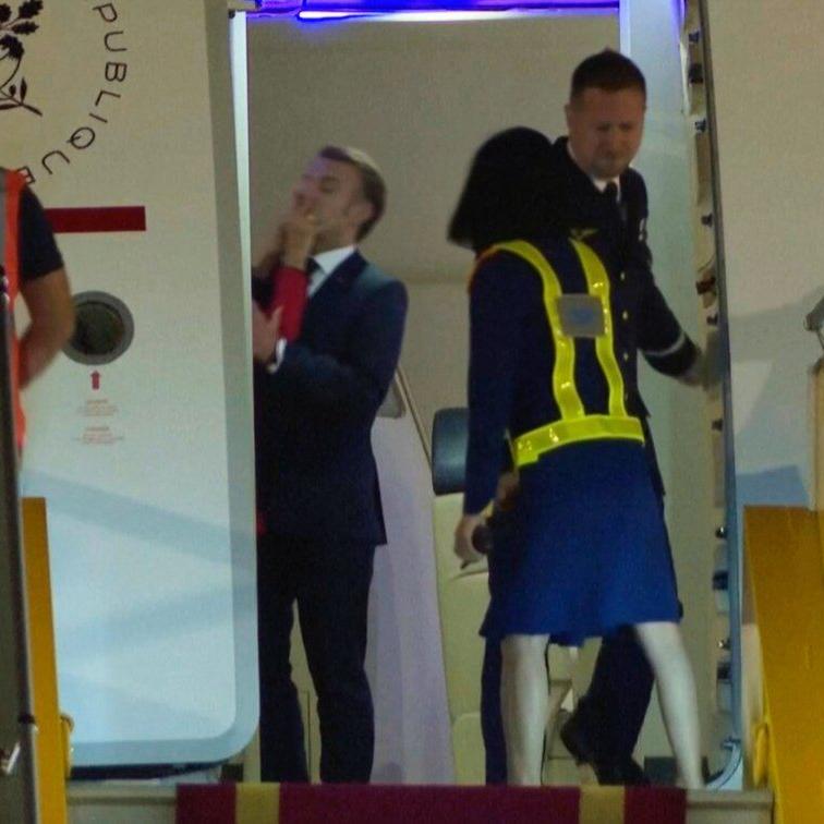 France's first lady seems to push her husband as they land in Vietnam. He says they were joking